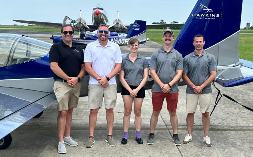 Hawkins Flight Academy instructors and team members standing on the Shelbyville ramp with training aircraft